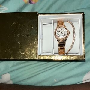 A woman’s Michael Kors rose gold with diamonds, watch, diamond studded bracelet
